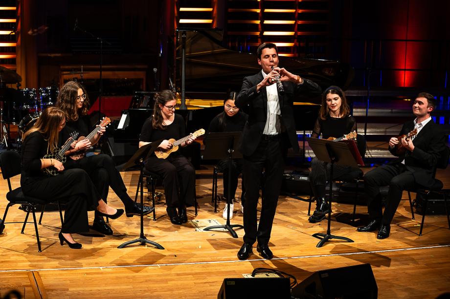 Sechs Studierende mit Okulele, ein Student spielt Klarinette.