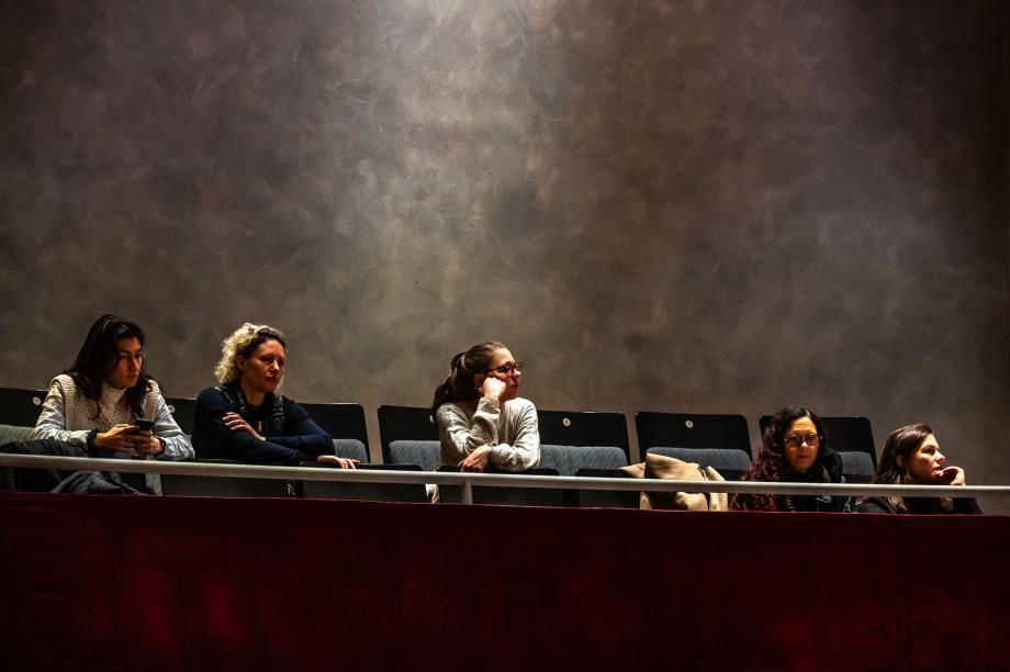 Studierende und Lehrende während der Eröffnung im Publikum des Konzertsaals. Sie schauen interessiert zur Bühne.