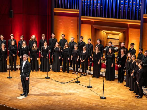 Der Kammerchor der HMDK in zweireihiger, halbrunder Aufstellung vor dem Konzertorgel.