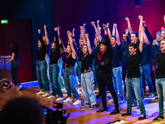 Die Mitglieder des Popchores reißen die Arme nach oben.